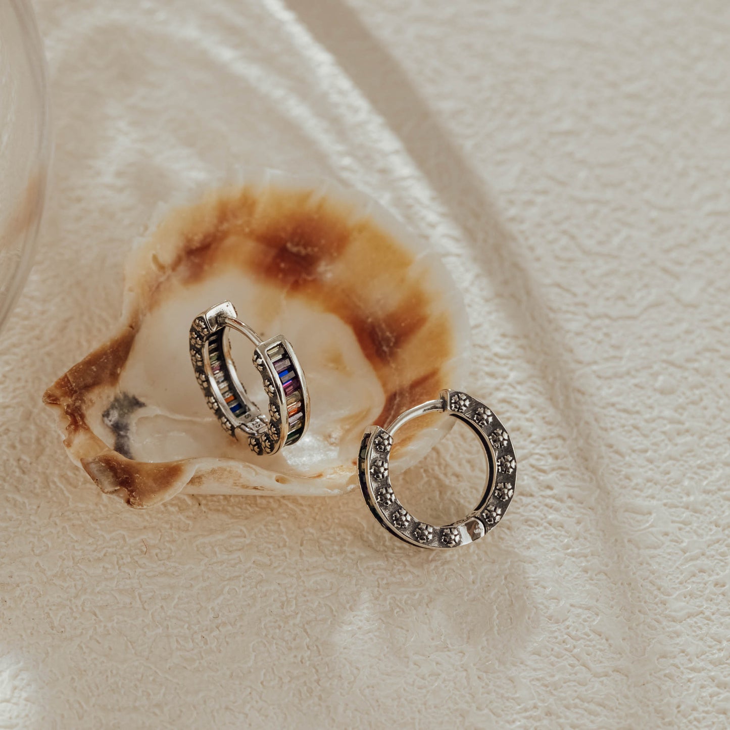 Back view of rainbow baguette huggie earrings showing silver detailing