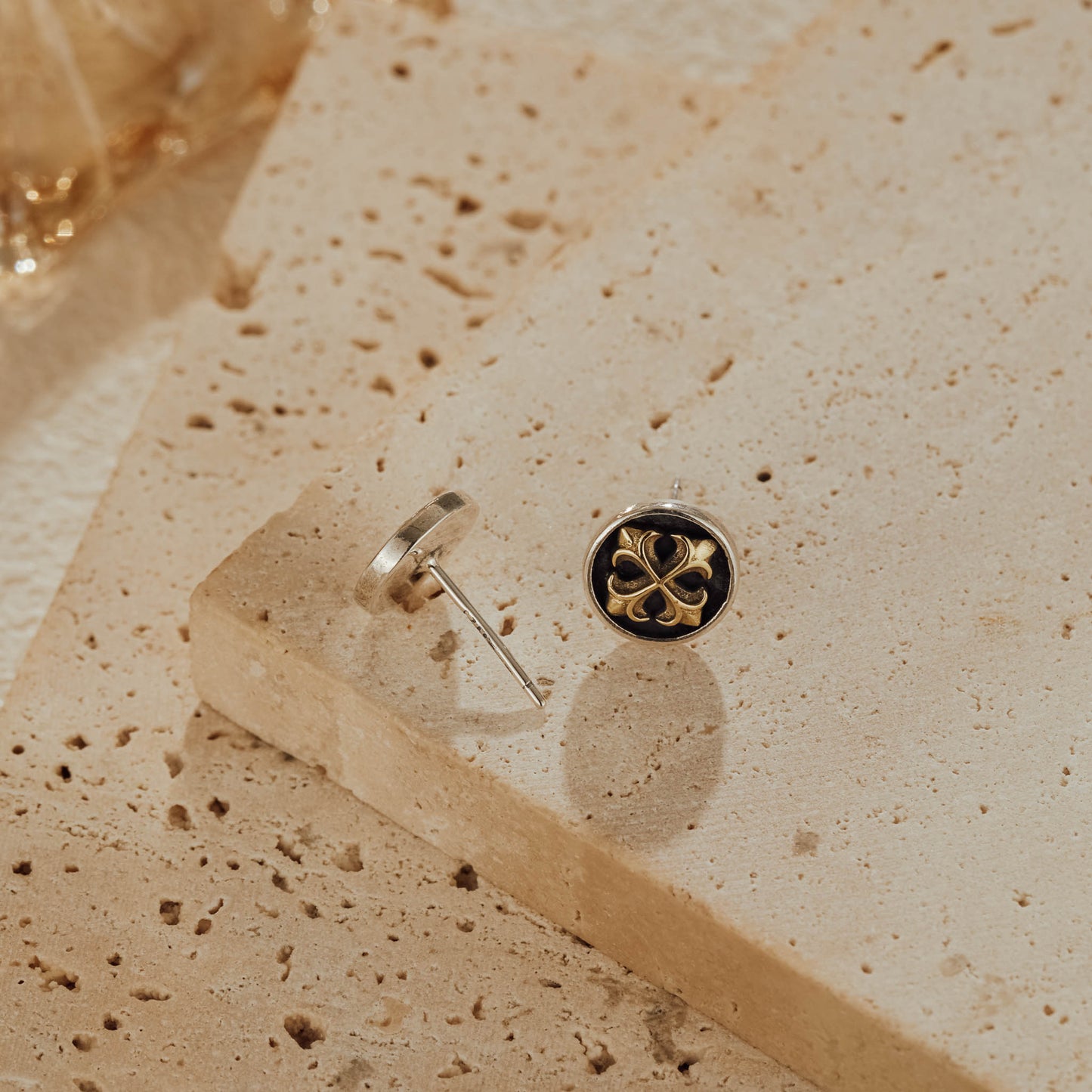 Front and back view of cross medallion earrings showing oxidized silver details