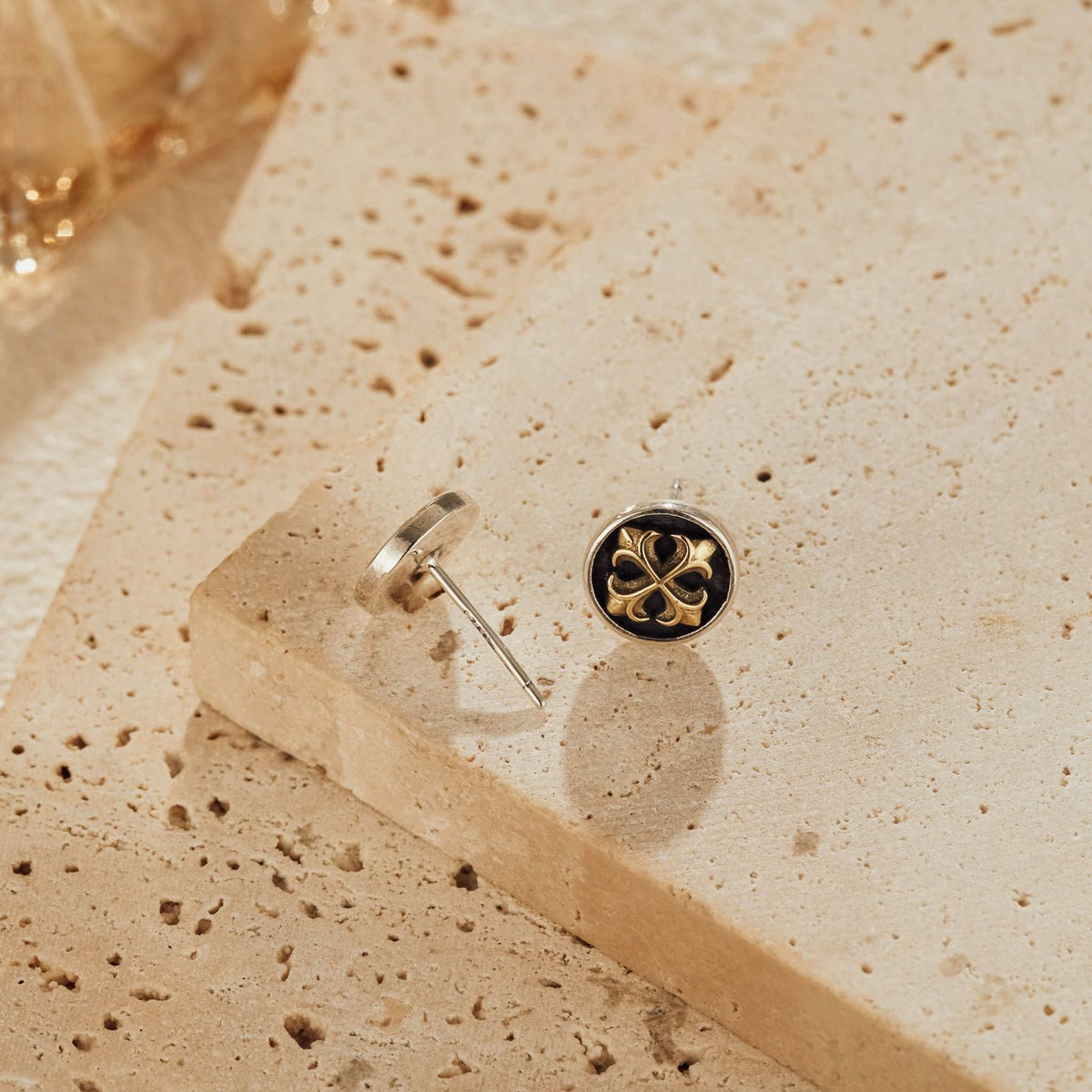 Front and back view of cross medallion earrings showing oxidized silver details