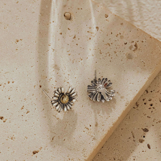 Front and back view of daisy stud earrings showing 925 hallmark and oxidized silver petals