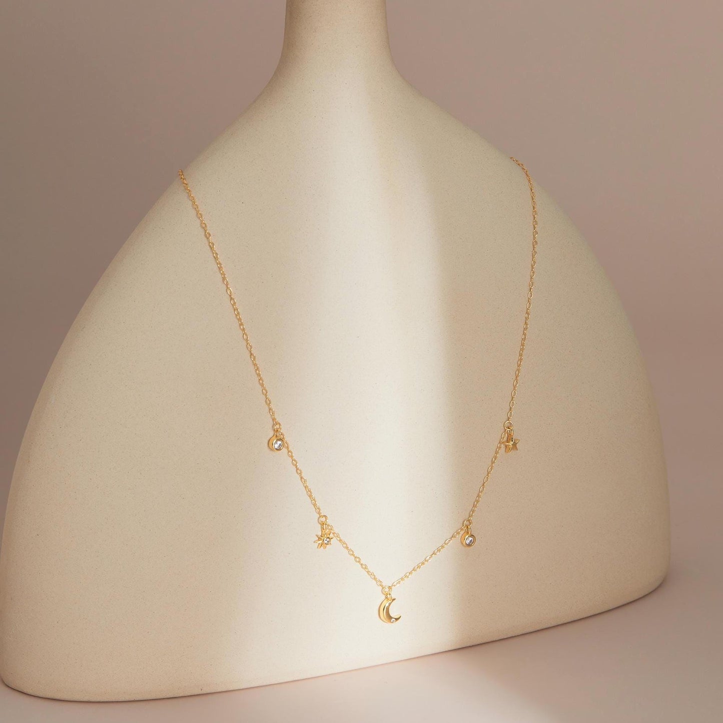 Gold on stand — Celestial Sparkle Necklace presentation shot.