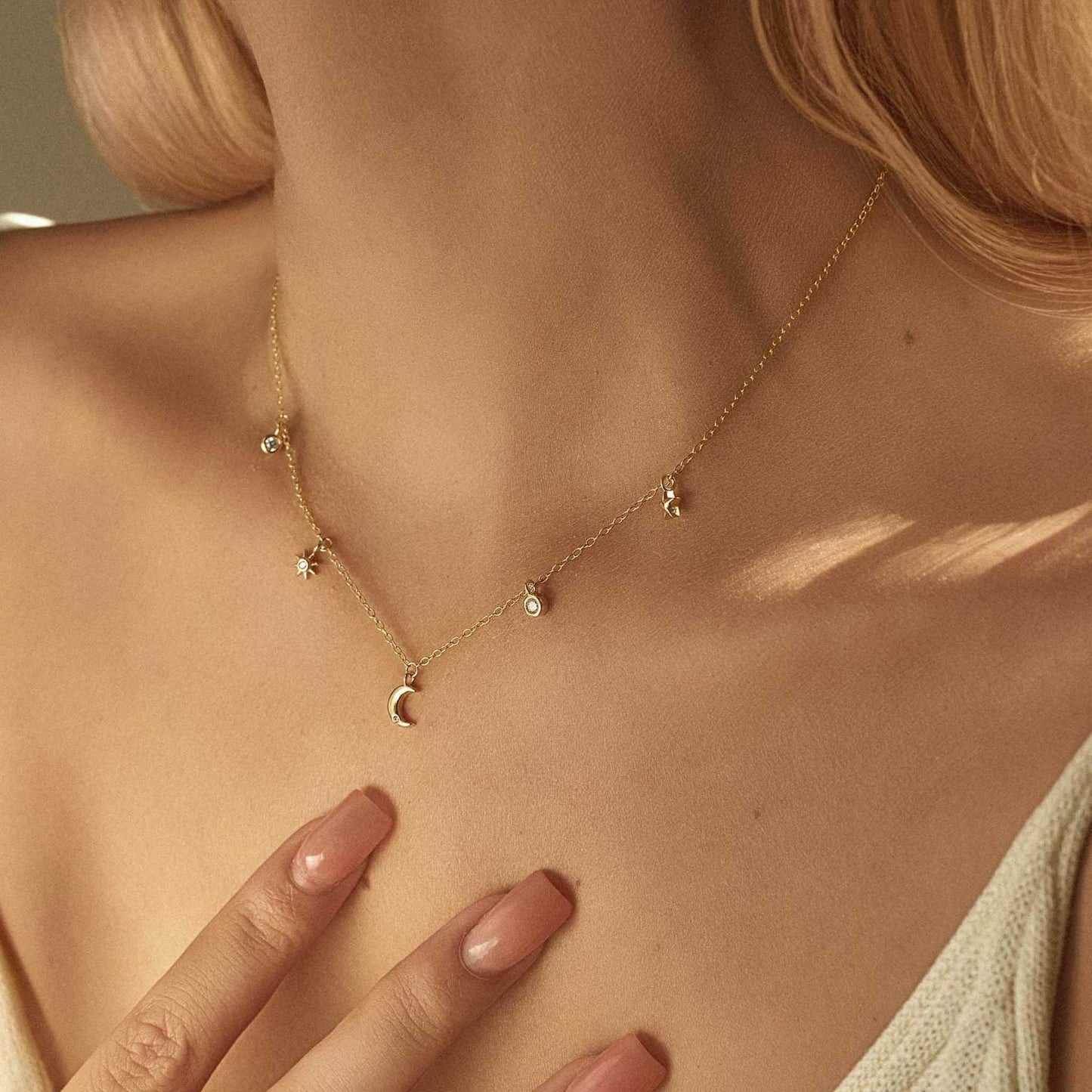 Gold close-up on model — Celestial Sparkle Necklace, moon & star charms, 14K gold plated sterling silver.