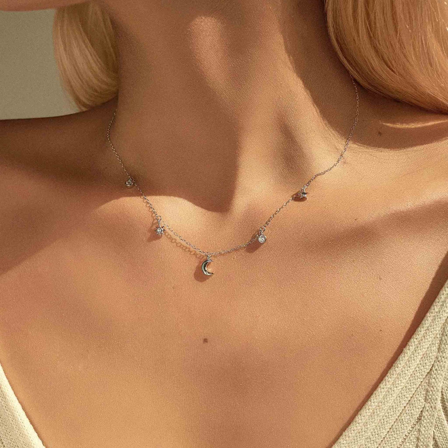 Silver close-up on model — Celestial Sparkle Necklace, moon & star charms, sterling silver.