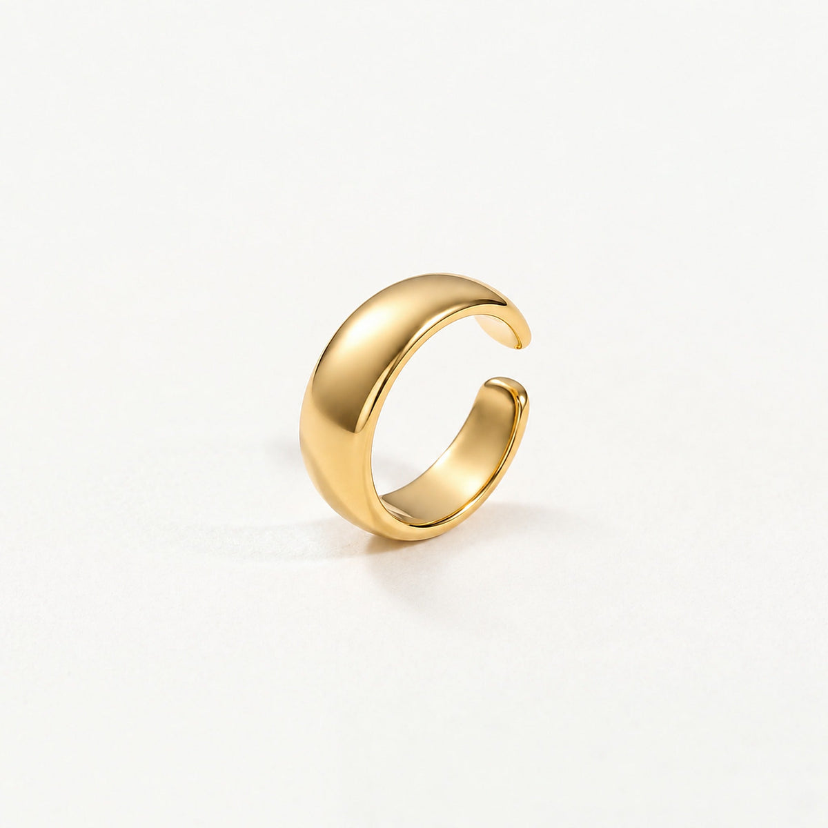 Gold-plated sterling silver dome ear cuff standing upright, open gap and smooth inner band in view