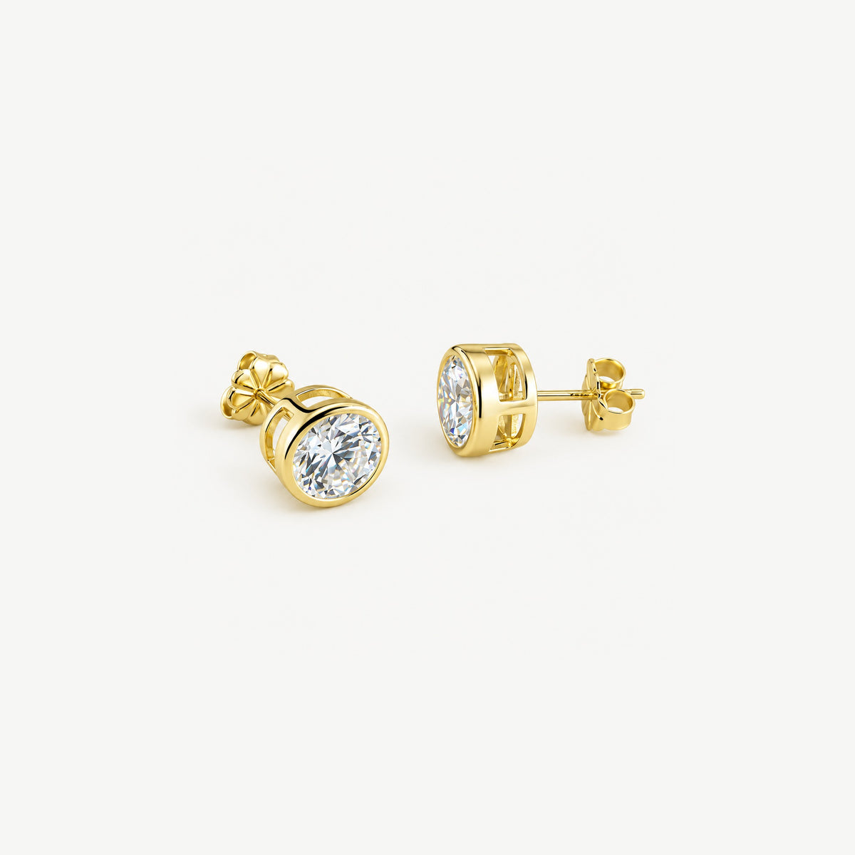 1 ct gold bezel moissanite studs with butterfly push backs, one facing front and one in side profile