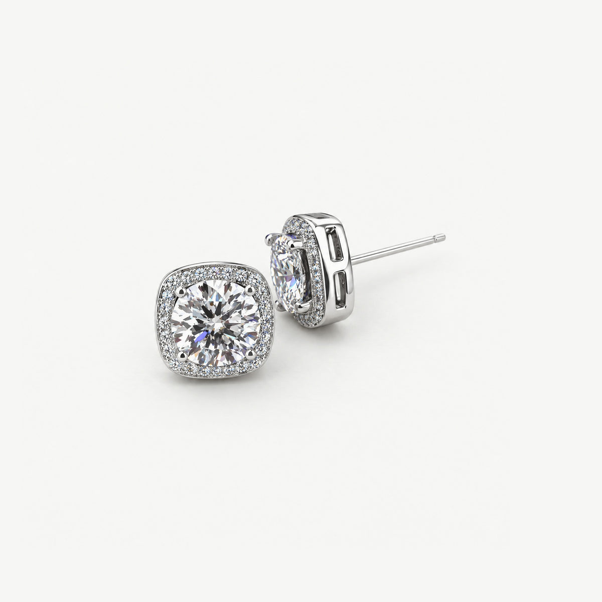 White 1ct moissanite halo stud earrings in sterling silver, one face-up and one on its side showing the post