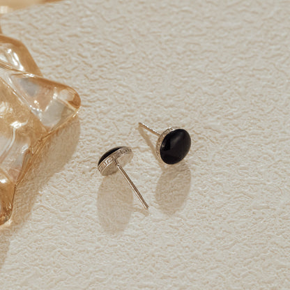 Side view showing engraved silver border on black CZ studs