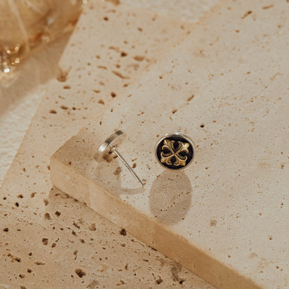 Front and back view of cross medallion earrings showing oxidized silver details