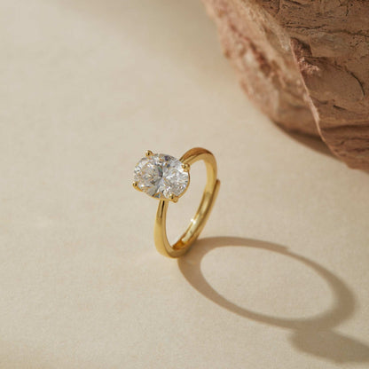 Minimalist adjustable gold plated sterling silver ring with oval cubic zirconia in soft light