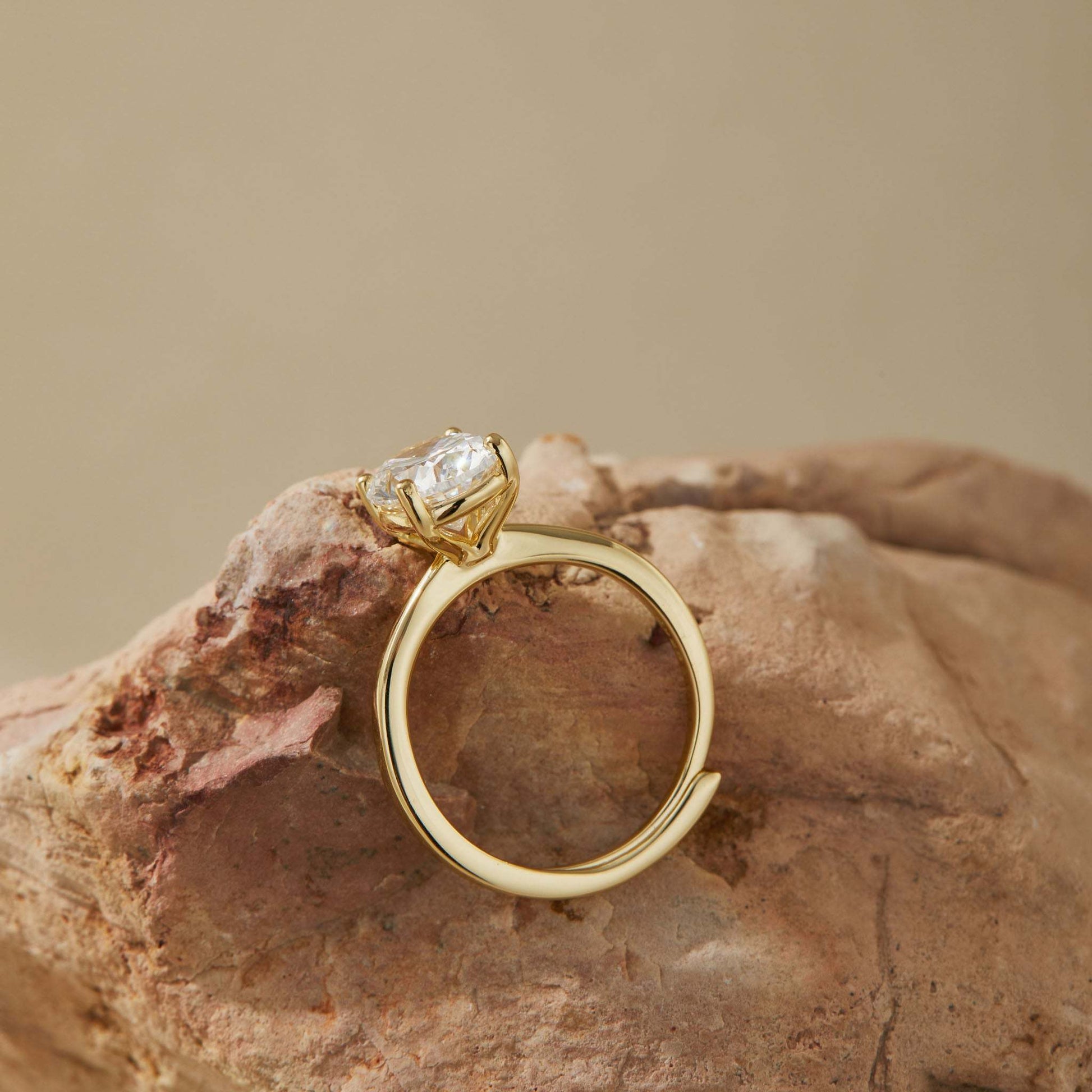 Side view of adjustable S925 sterling silver ring with 14K gold plating and oval stone
