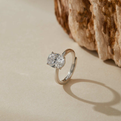 Close view of adjustable white gold plated sterling silver ring highlighting oval stone sparkle