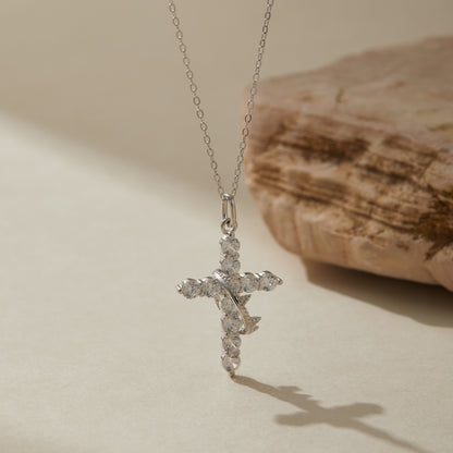 Silver crown cross necklace showing sparkle under light