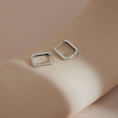 Rectangular S925 huggie earrings capturing natural light