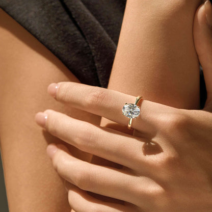 Adjustable 14K gold plated S925 sterling silver solitaire ring worn on hand in warm sunlight