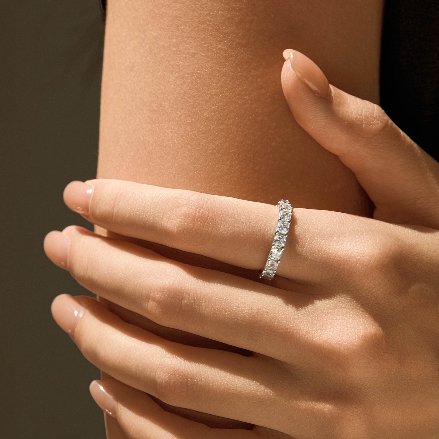 Model wearing reversible S925 silver eternity ring on finger