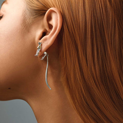 Side view of model showcasing Egyptian cat statement dangle earring