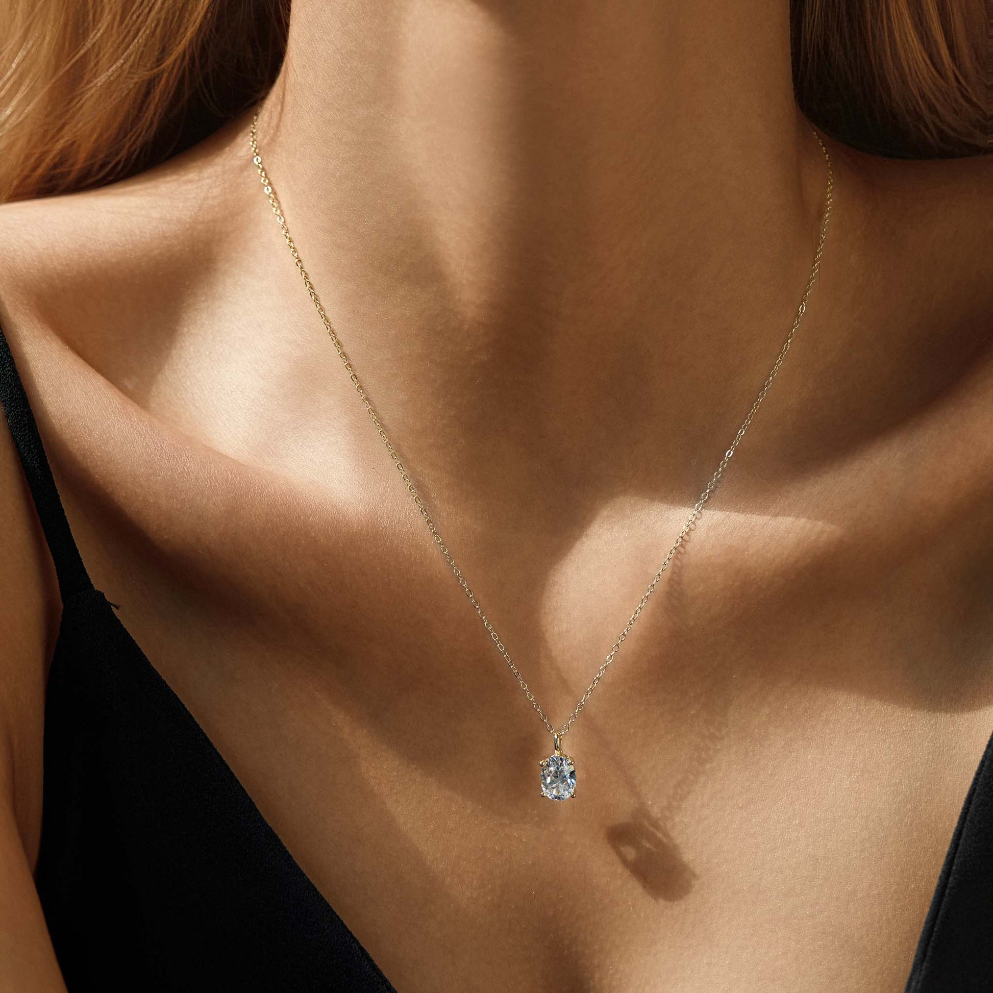 14K gold plated sterling silver necklace with solitaire cubic zirconia pendant, worn on model