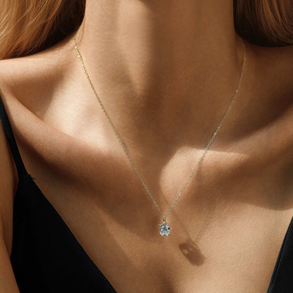 14K gold plated sterling silver necklace with solitaire cubic zirconia pendant, worn on model