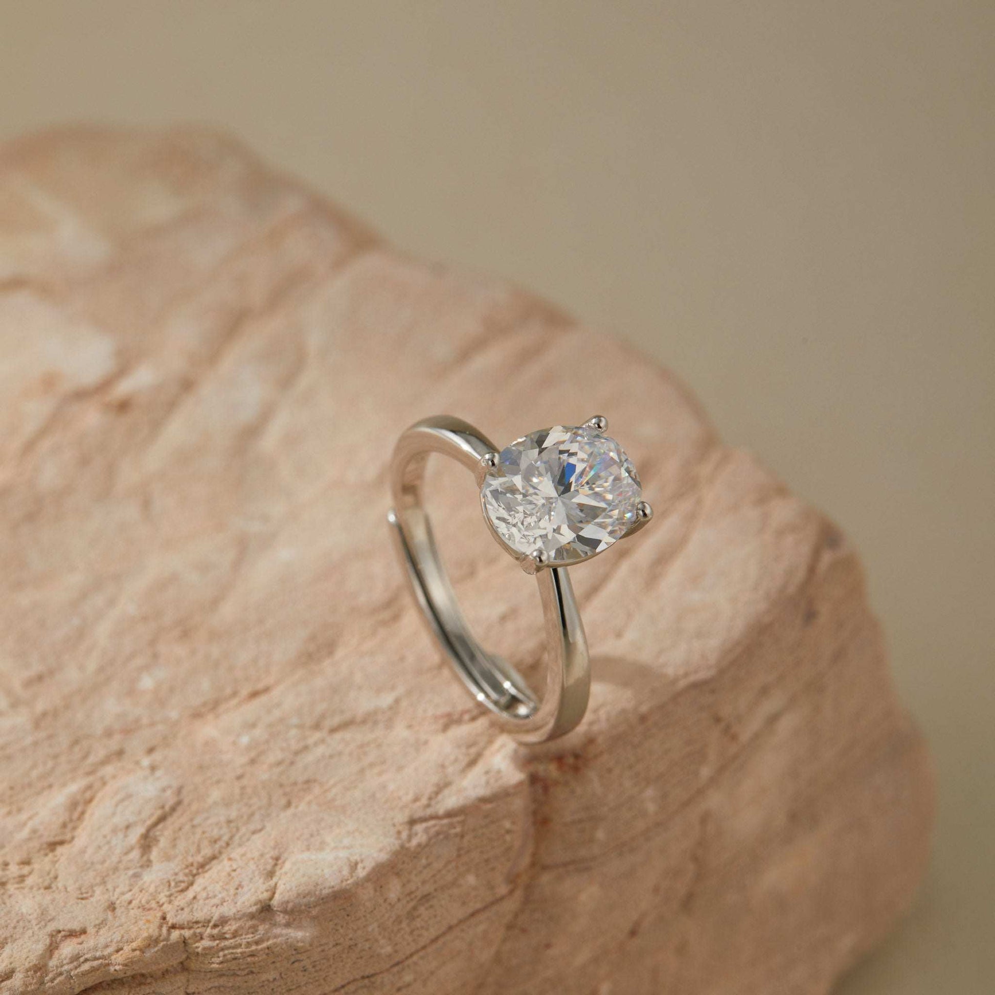 Adjustable white gold plated sterling silver solitaire ring with oval cubic zirconia on stone