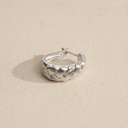 Brushed sterling silver braided huggie hoop earring with pavé accents and hinged closure, side angle