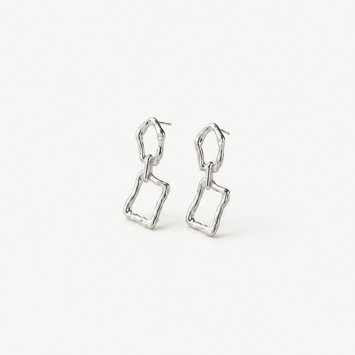 Pair of sterling silver chain link dangle earrings standing upright, molten oval top link above a wavy rectangular frame