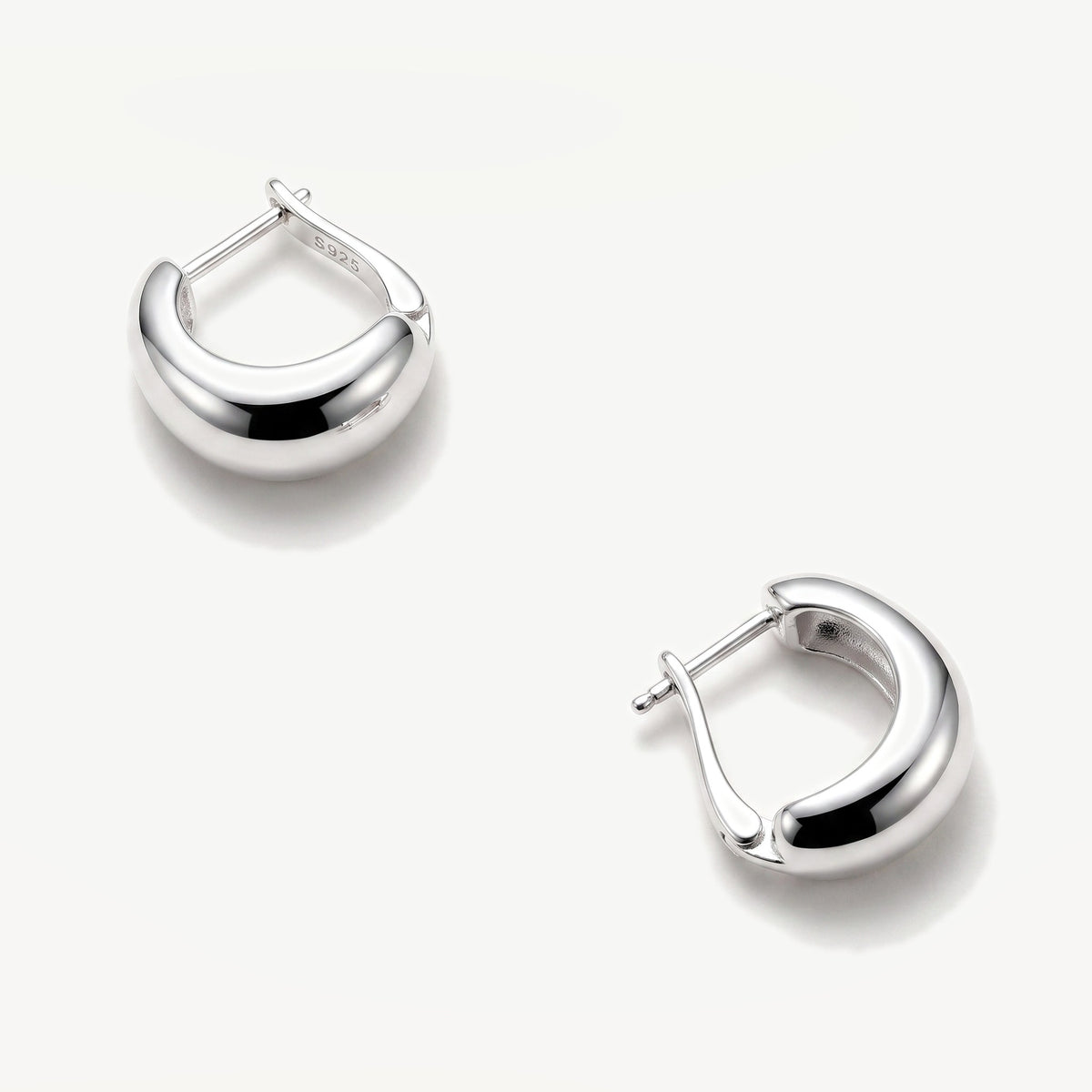 Sterling silver chunky dome huggie earrings viewed from above showing the tapered inner band