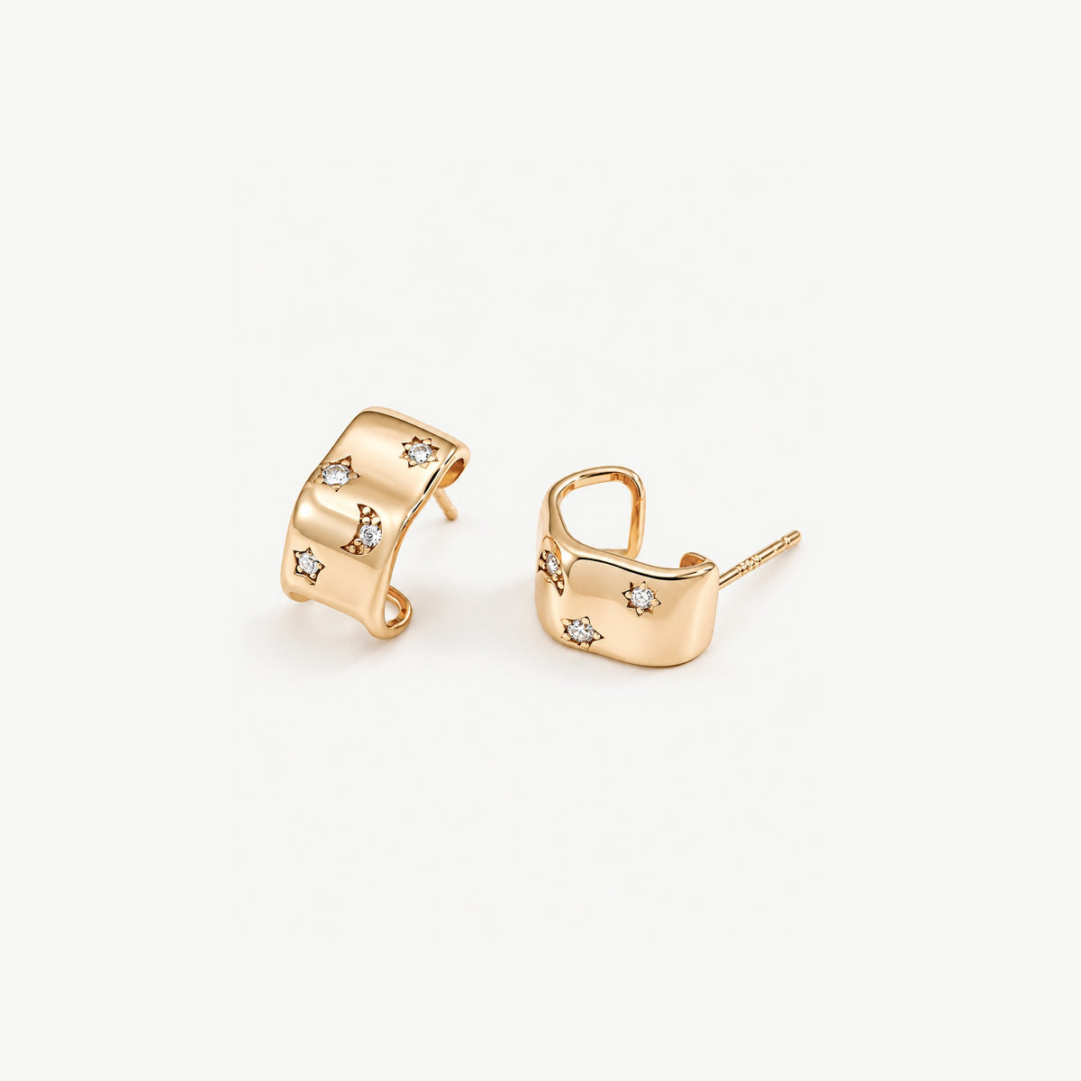 Gold-plated celestial half hoop earrings at an angle, showing the wavy band, the open C shape and straight posts