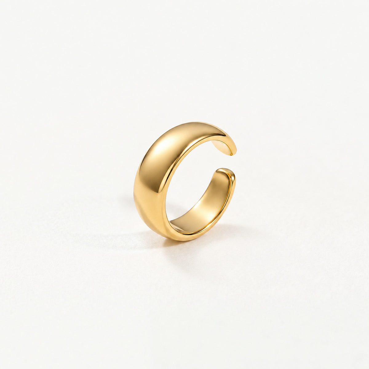 Gold-plated sterling silver dome ear cuff standing upright, open gap and smooth inner band in view