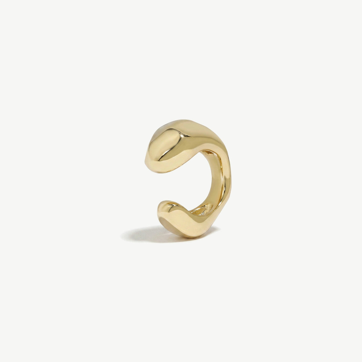 Gold plated sterling silver ear cuff at a raised angle, showing the depth of the curved band