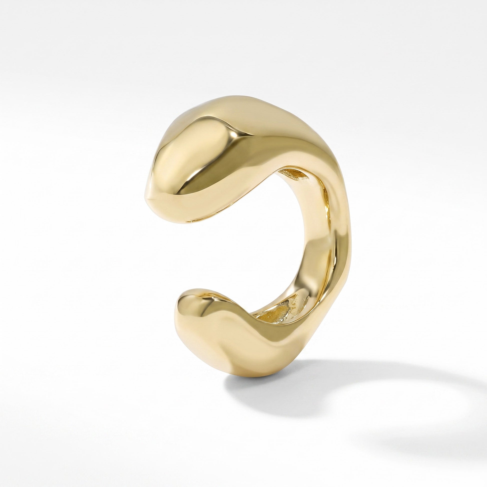 Gold plated sterling silver ear cuff with a smooth sculpted band, shown on plain white background
