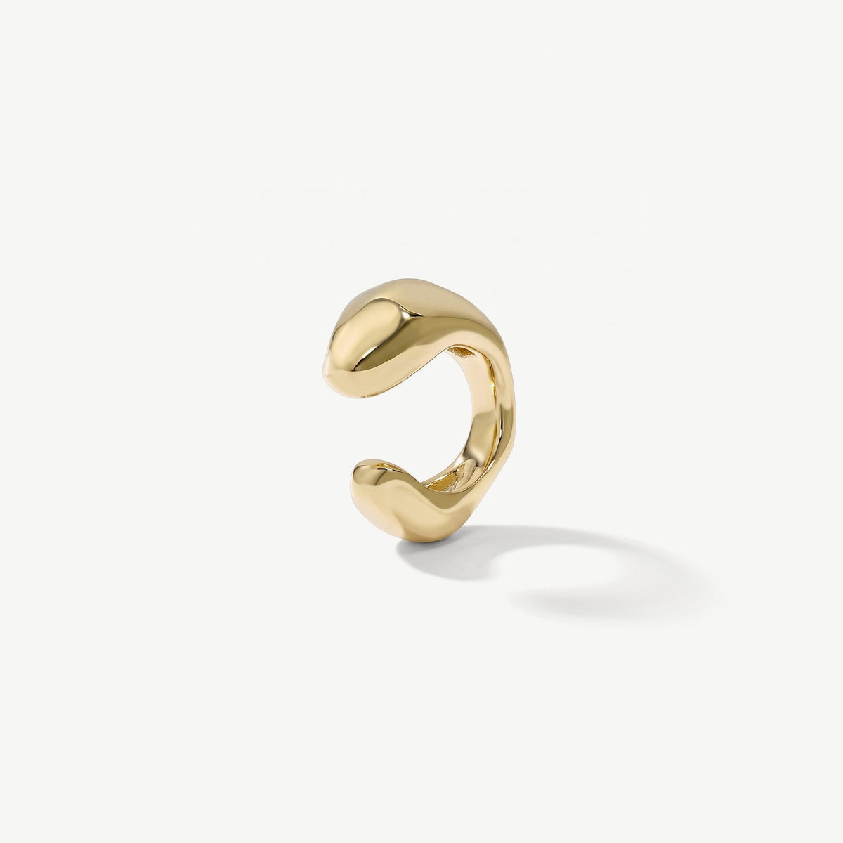 Gold plated sterling silver ear cuff with a smooth sculpted band, shown on plain white background
