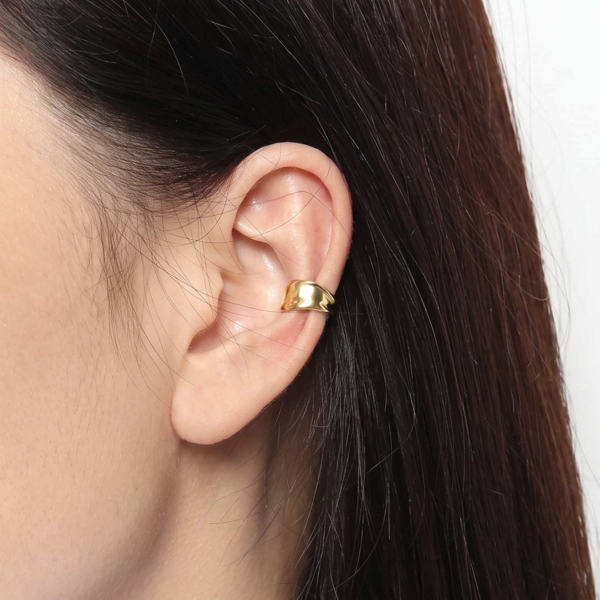 Gold plated cuff earring curved over the ear rim, sliding on with no piercing needed