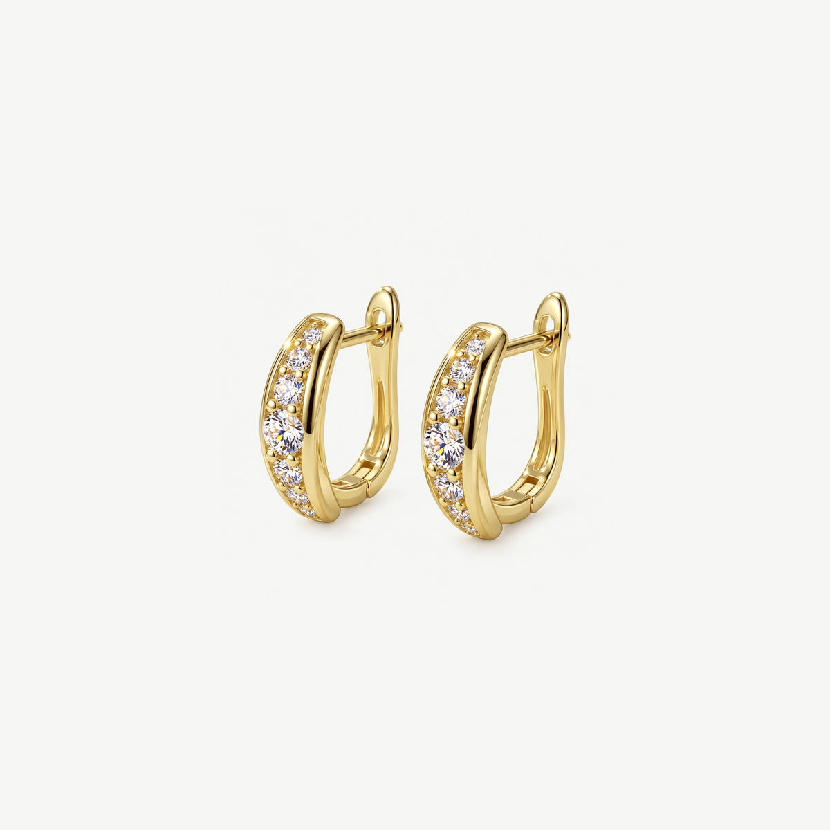Two gold plated sterling silver huggie hoops angled side by side, each set with seven graduated moissanite stones
