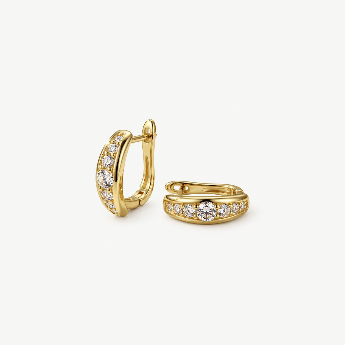 Pair of 14k gold plated moissanite huggie hoop earrings, one upright and one lying flat to show the stone row