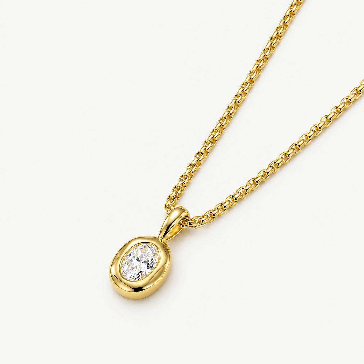14k gold plated stainless steel oval pendant necklace on a box chain, oval-cut clear stone in a softly wavy bezel