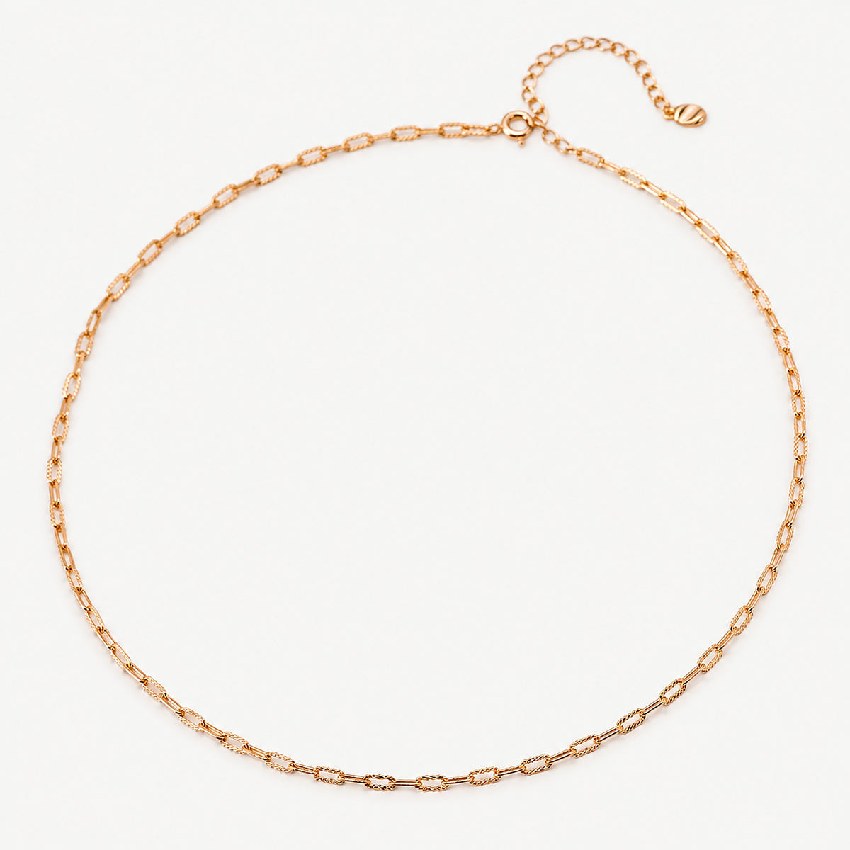 Gold-plated sterling silver paperclip chain necklace laid in a circle, faceted links, spring ring clasp and extender