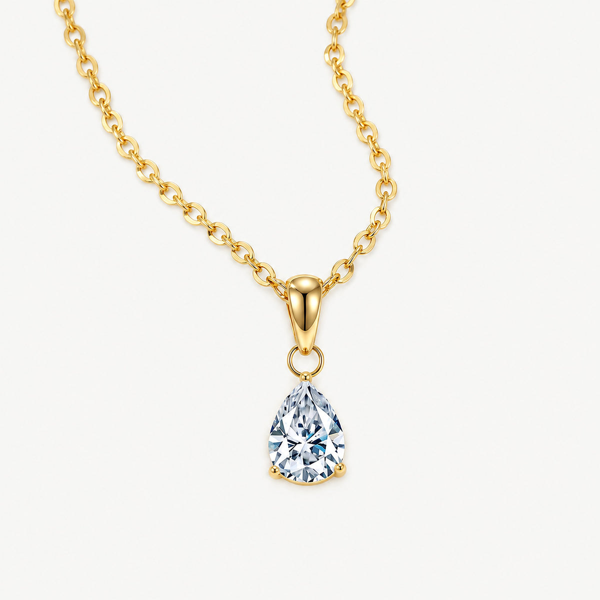 14k gold plated stainless steel pear necklace, a pear-cut clear stone in three prongs below a rounded bail