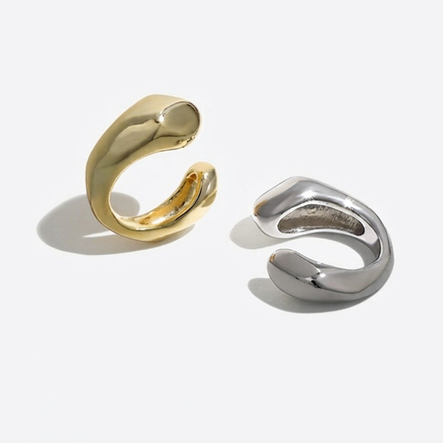 Gold plated and sterling silver ear cuffs side by side showing both colourways, sold singly