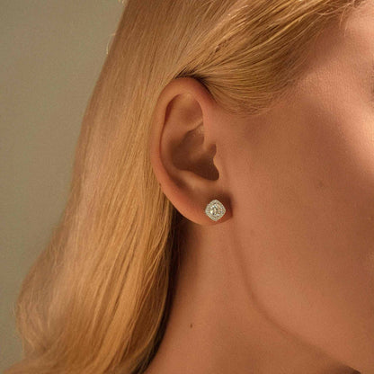 Lifestyle close-up — White moissanite halo stud earring on model.