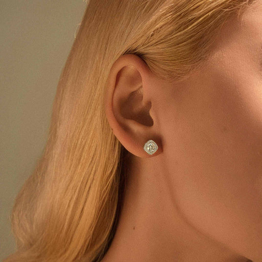 Lifestyle close-up — White moissanite halo stud earring on model.