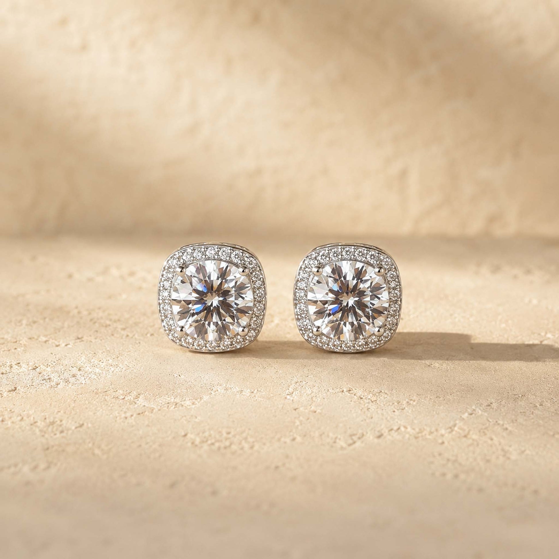 Close-up of 1ct round cut white moissanite halo stud earrings on sterling silver, pavé halo detail