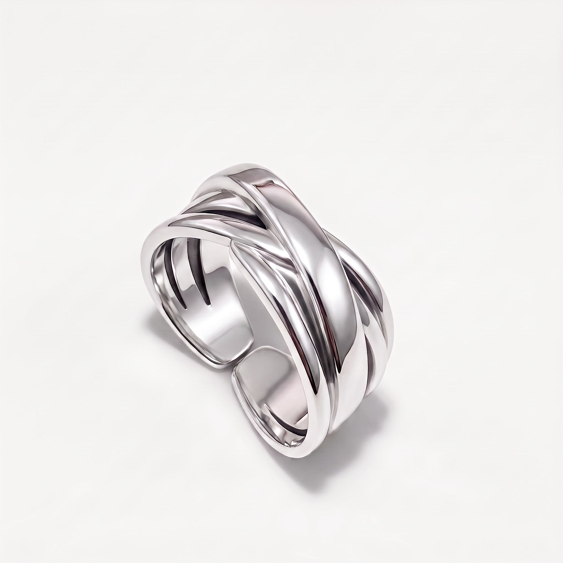 Sterling silver crossover ring at an angle showing the open adjustable back of the band