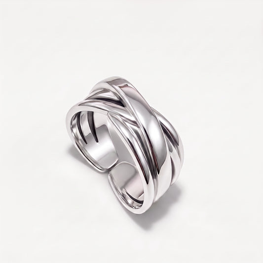Sterling silver crossover ring at an angle showing the open adjustable back of the band