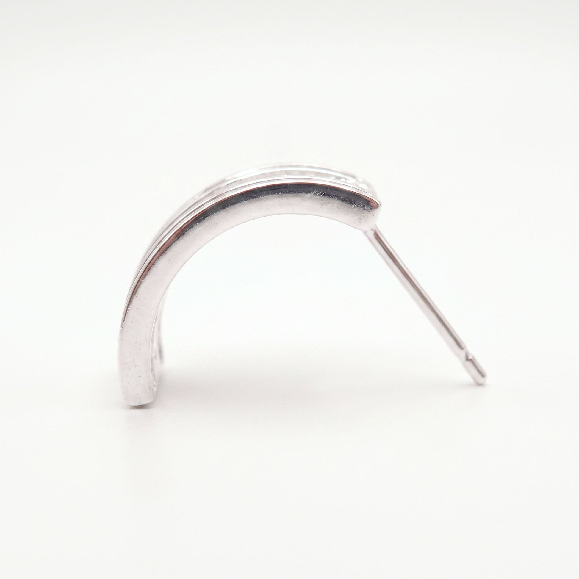 Side profile of a sterling silver half hoop earring showing the shallow arc and long post fitting