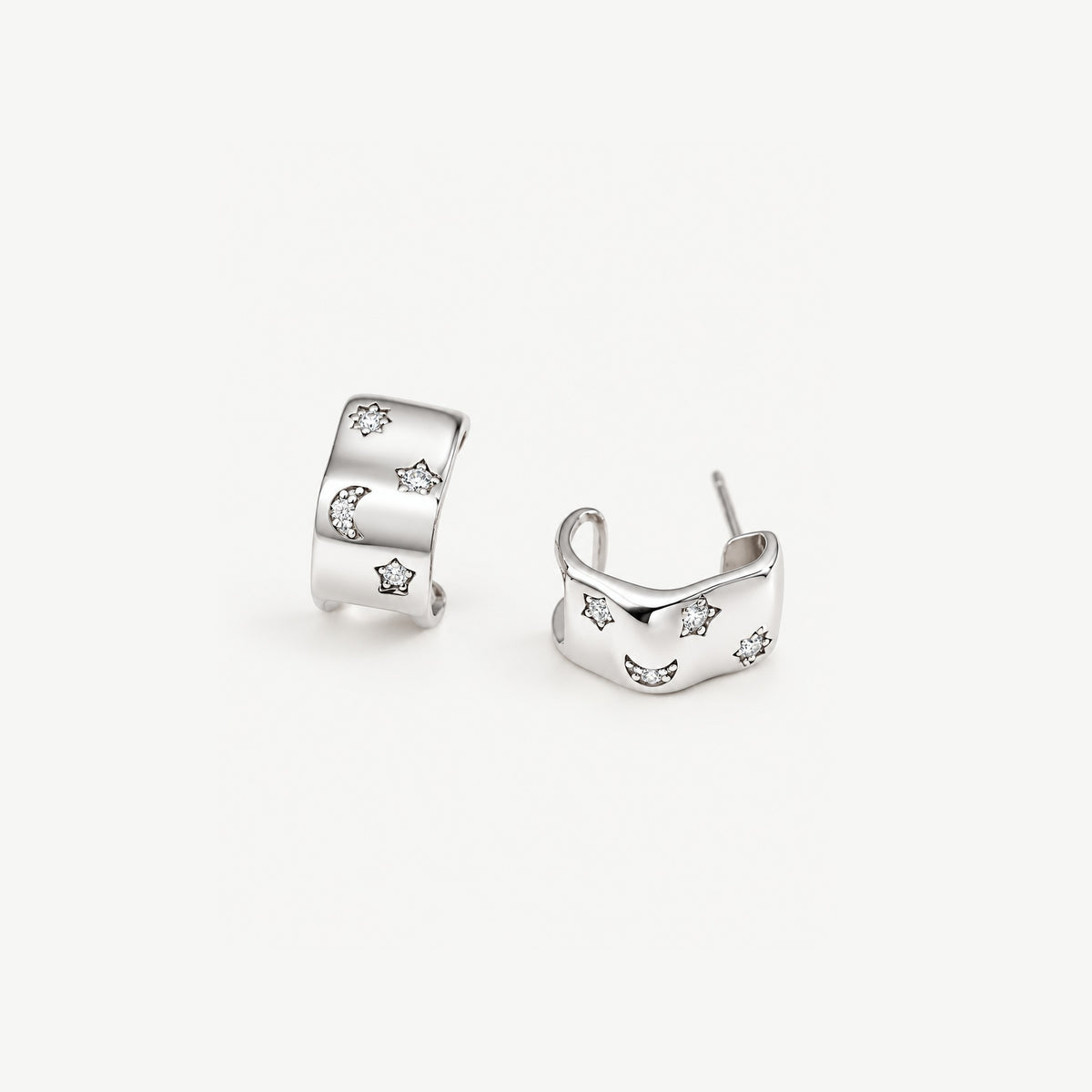 Sterling silver celestial half hoop earrings, one turned to show the open C back and the post behind the band