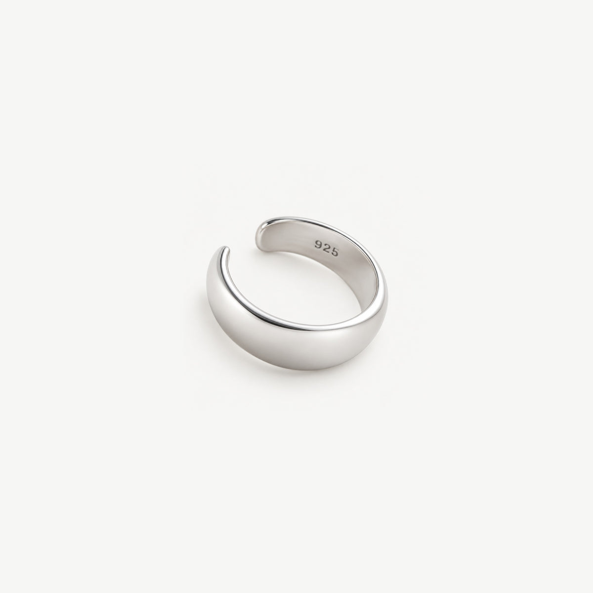 Close view inside a sterling silver dome ear cuff, the 925 stamp struck on the polished inner band