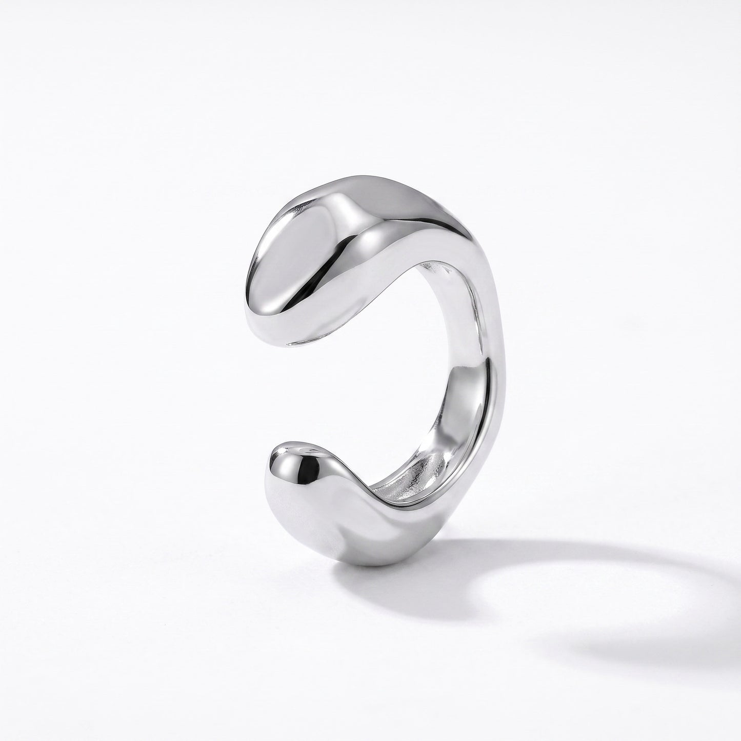 Sterling silver ear cuff with a smooth sculpted band, shown from the open side on white background
