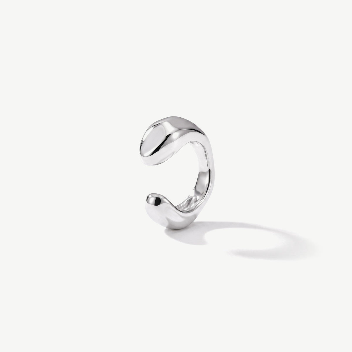Sterling silver ear cuff with a smooth sculpted band, shown from the open side on white background