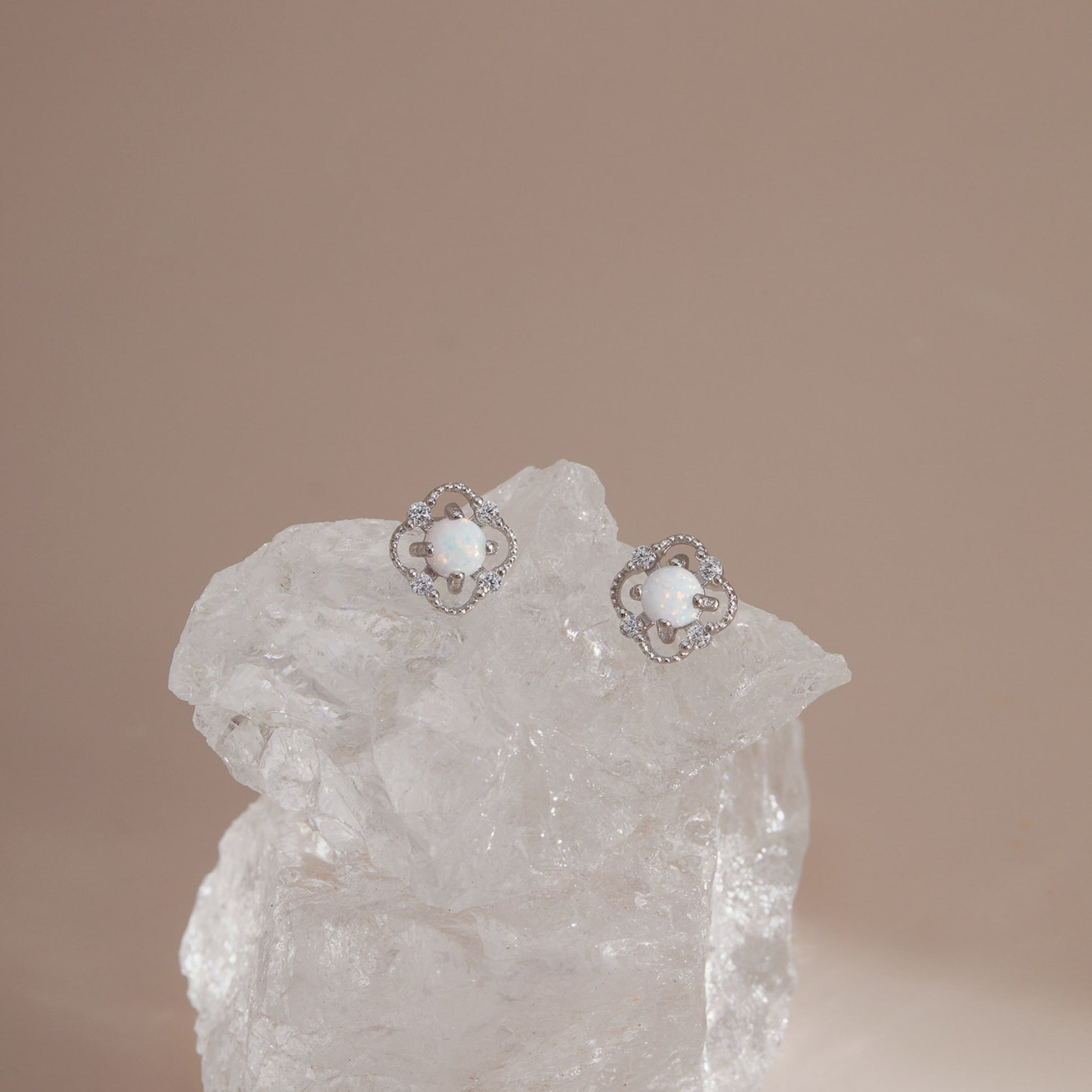 Silver S925 floral opal stud earrings on clear crystal in soft neutral light