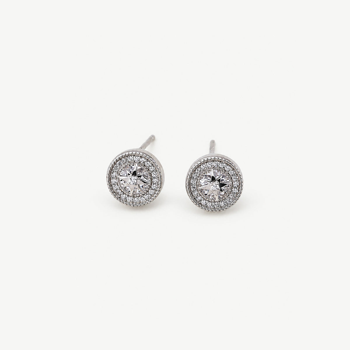 Front view of sterling silver starburst halo studs, the eight-point star centered over a large faceted clear stone